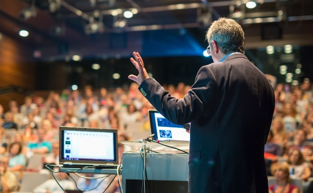 Man presenting to large crowd